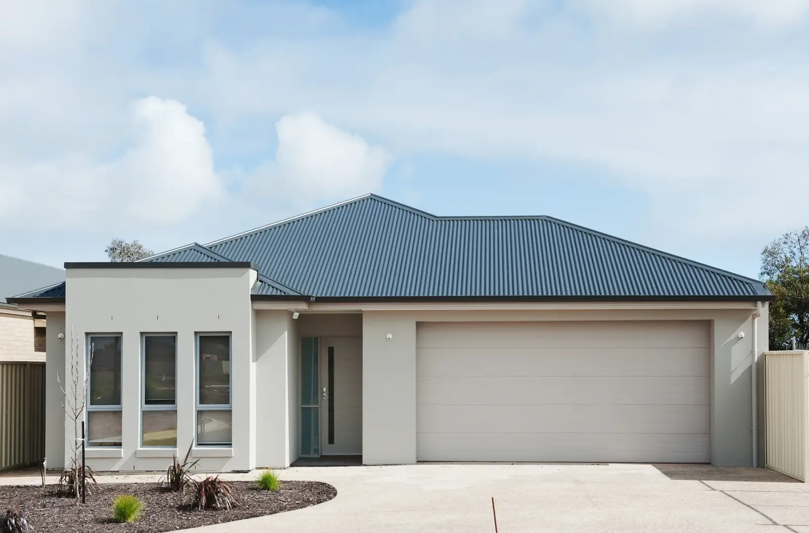 Concrete driveway leading to a home's garage